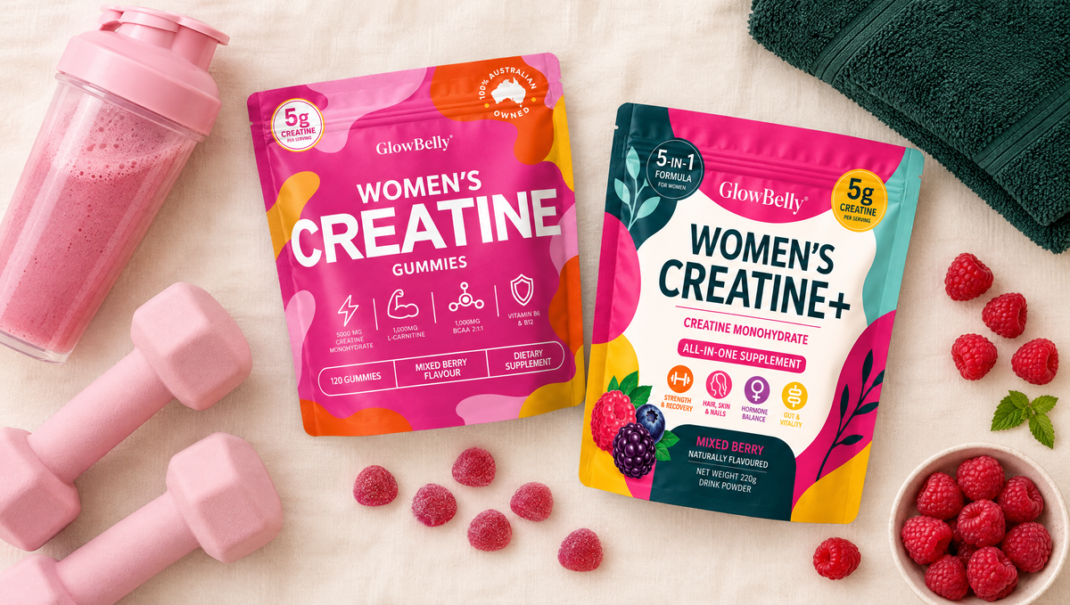 GlowBelly Women's Creatine Gummies and Women's Creatine+ Berry pouches with pink dumbbells, a berry drink shaker and raspberries on a cream background